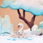 Close up of a Bumbu swan toy on a Bumbu wooden ice floe surrounded by miniature cygnet figures in a winter scene