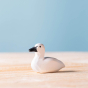 Close up of the Bumbu miniature wooden cygnet toy on a wooden surface
