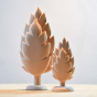 Bumbu hand made small and large thuja tree toys on a beige worktop