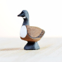 Close up of the Bumbu eco-friendly wild goose animal toy figure stood on a light wooden background