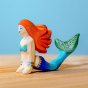 Bumbu wooden Mermaid toy with red hair and a blue and green tail, on a blue background.