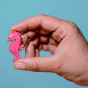 Bumbu pink wooden Seahorse figure, held by a hand for size reference.