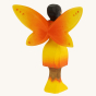 The back of the Bumbu Wooden Sunflower Fairy. A bright and cheerful wooden Sunflower Fairy has their arms outstretched in front of them. The sunflower Fairy has painted black hair, brown skin, yellow and orange wings with small orange spots, a yellow and 