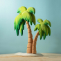 Bumbu Wooden Palm Tree. The toy sits on a wooden surface against a blue background.