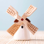 Bumbu Miniature Wooden Moldova Windmill. The toy sits on a wooden surface against a blue background.