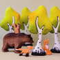 Bumbu animlas surrounded by Bumbu Wooden Birch Trees. The animals are of a bear with a squirrel sitting on its back, a standing fox and a sitting fox