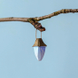 Bumbu Wooden Miniature Toy Lantern hanging from a twig