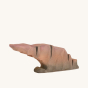 Bumbu Wolf Howling Stone is a handmade wooden toy rock. A carefully hand crafted and hand painted realistic looking rock in reds and browns, showing the natural woodgrain, on a cream background