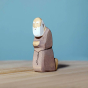 Bumbu Handmade Wooden Joseph figure kneeling on a blue background and wooden table