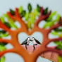 A view of two Bumbu Wood Peckers sitting together on a Bumbu Rock. The photo is taken from the perspective of looking through the heart cut out of the Bumbu Heart Tree, and looking towards to Wood peckers