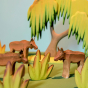 A Bumbu Wooden Banana Bush surrounded by family of moose figures, a Bumbu willow tree can be seen in the background 
