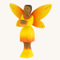 Bumbu Wooden Sunflower Fairy. A bright and cheerful wooden Sunflower Fairy has their arms outstretched in front of them. The sunflower Fairy has painted black hair, brown skin, yellow and orange wings with small orange spots, a yellow and orange dress and