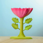 The Large Pink Flower by Bumbu is an impressive wooden flower with four leaves and a rich pink bloom, it stands on a green wooden base, with a blue background. 
