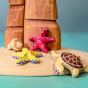 Bumbu Wooden Red Starfish Set posed in a beach scene with the Bumbu Wooden Turtle Toy.