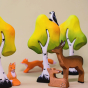 A Bumbu Wooden Deer and Fox family happily playing next to the Bumbu Wooden Birch Trees, as a miniature Bumbu Wood Pecker watches from the tree tops