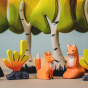 A Bumbu Wooden Fox family sit together underneath the branches of the Bumbu Wooden Birch Trees