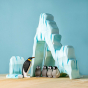 The Bumbu Icy Cliffs is a set of 5 handmade wooden blocks that stack together to make an icy mountain scene. With a family of wooden penguins arranged at the base.
