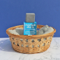 Picture of the Lamazuna Charcoal Yourself oily and combination skin Cleansing Bar with its blue box, in a basket.