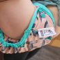 Baby wearing Pop-in light pink Ferret popper Nappy all in one nappy with green trim details