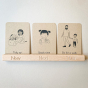 Coach House hand painted kids daily routine flashcards slotted into a Coach House beech wood flashcard holder on a grey background