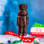 Close up of the Cocoa loco fairtrade dark chocolate soldier lolly on a blue blurred background