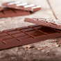 Close up of the Cocoa Loco organic milk chocolate bar on a wooden background
