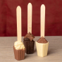 3 Cocoa Loco organic hot chocolate spoons on a wooden table next to a red background