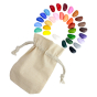 32 coloured Crayon Rocks laid out in a spiral next to their cotton muslin bags on a white background