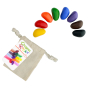 8 natural soy wax Crayon Rocks laid out on a white background next to their cotton muslin bag