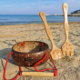 Dr Zigs Beach Creativity Kit shown on a sandy beach. The kit includes two bamboo tools and a coconut bowl