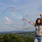 person making giant bubbles