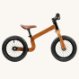 Side of the Early rider wooden 12 inch balance bike on a beige background