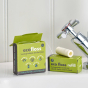 Ecoliving biodegradable plant-based vegan tooth floss and refill packs on a white sink next to a metal tap
