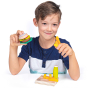 A young child plays with the Erzi Veggie Burger Assortment Wooden Play Food Set.