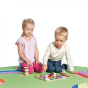 Two children playing the eco-friendly wooden Erzi cake tower board game on a white background