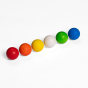 Colourful rainbow Erzi 6 Wooden Balls Marble Set lined up in  a row. The colours of the balls from left to right are red, orange, yellow, white, green and blue