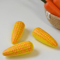 Three Erzi Sweetcorn Corn Cob Wooden Play Food with a natural woven bowl full of wooden toy carrots