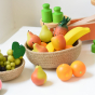 Erzi Banana Wooden Play Food in a Respiin bowl of mixed wooden fruit toys.