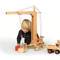 Child playing with the Fagus eco-friendly wooden crane toy on a white background