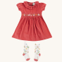 frugi amilie party outfit rosehip red dress with bunny detail and white tights with flower pattern