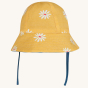 Frugi Chambray Bumblebee Yellow Daisies Helen Reversible Hat shown on daisy print side pictured on a plain background