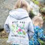 A child wears the Frugi Switch Lissie Hoodie - Grey Marl / Wild And Wonderful in an outdoor setting.