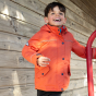 A young child wears the Frugi Rambler 3 in 1 Coat - Paprika in an outdoor setting.