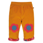 Reversible Frugi gold and scandi flower cotton cord kids trousers on a white background