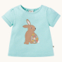 Frugi Evie Applique T-Shirt - Rabbit. A beautiful light mint green GOTS Organic Cotton, short sleeve t-shirt, with a light brown rabbit with embroidered flowers and a white fluffy tail, on a cream background.