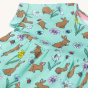 A closer look at the waist and dress pleats on the Frugi Organic Cotton Tallie Dress - Riverine Rabbits. Made with GOTS Organci Cotton, this dress is a beautoful mint green colour, with decorative brown rabbits, yellow, white and pink flowers, bees and la