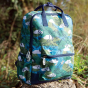 Frugi Explorers Backpack - Birds of Prey. The bag sits on a rock outdoors.