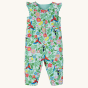 The tropical print side of the Frugi Children's Organic Cotton Etta Reversible Playsuit - Tropical Birds / Spring Dobby. A beautiful reversible play-suit, filled with colourful tropical birds and flowers on one side, and a plane mint green with a parrot a