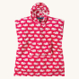 Frugi Children's Organic Cotton Havana Hooded Towel - Raspberry Whales. A hot pink hooded towel with white while horizontal whale print. The inside of the towel is white with hot pink whale print, with blue piping. On a cream background