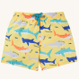 Frugi Boscastle Board Shorts - Banana Sharks, made from recycled bottles. A light banana yellow short with fun and colourful shark print, with a light blue draw string on the waist, on a cream background
